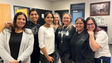 Group of Support Staff gathered together smiling