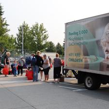 Food items being handed to families by volunteers