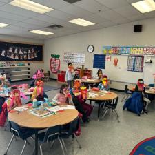 Classroom of students showing off dragon art.